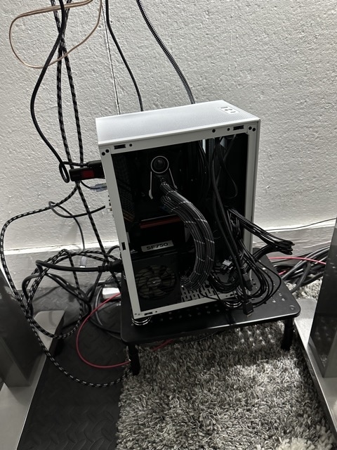 a computer with its side panel open and cables everywhere